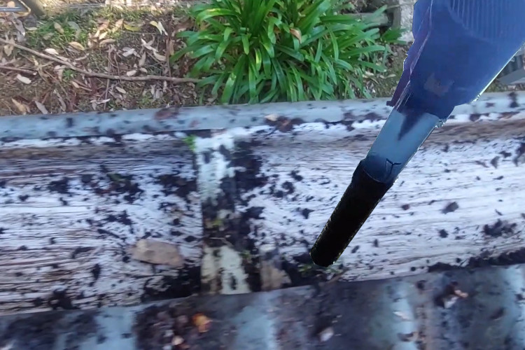 
wollongong gutter cleaner achieves precision by using a blower to remove small debris from guttering.
